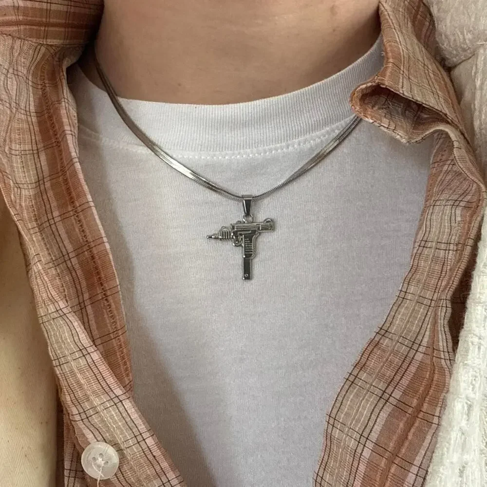 Flat lay silver uzi pendant